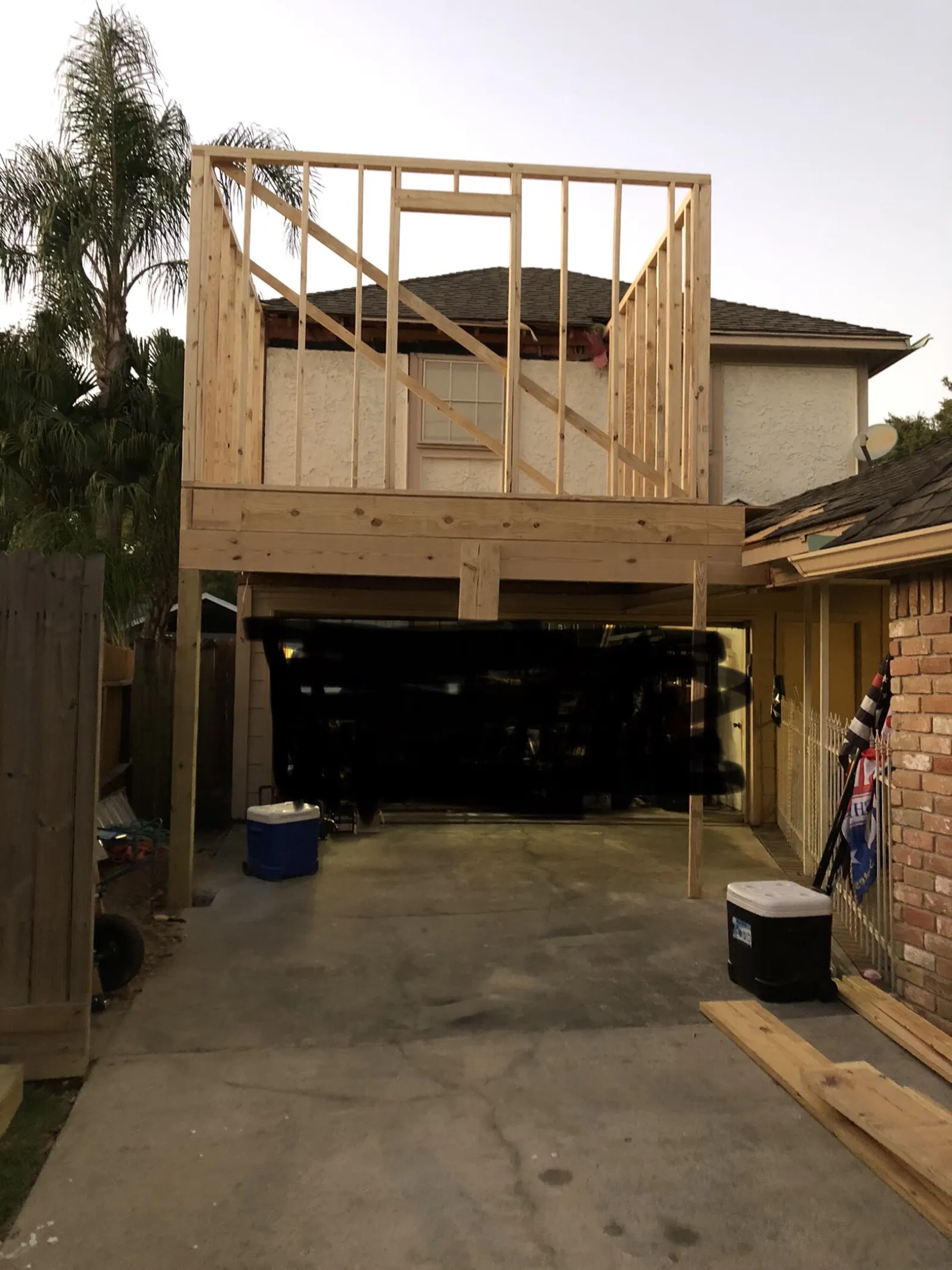 Second-story room addition framed in wood above an existing garage