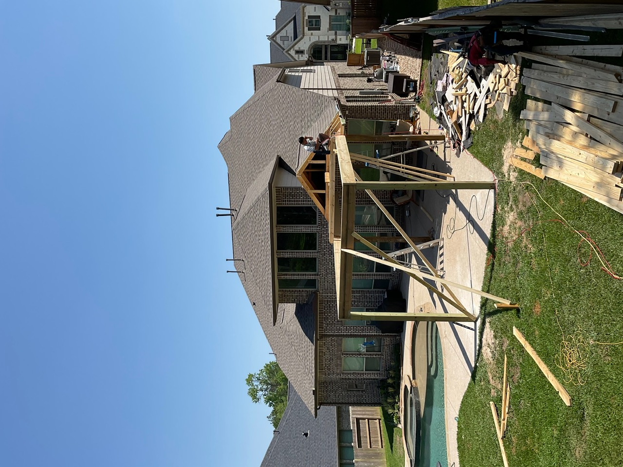 Covered patio addition under construction with wood framing