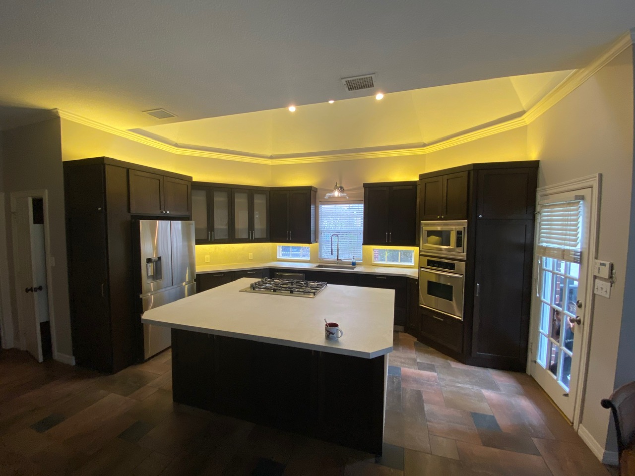 Kitchen remodel with dark espresso cabinetry and quartz island