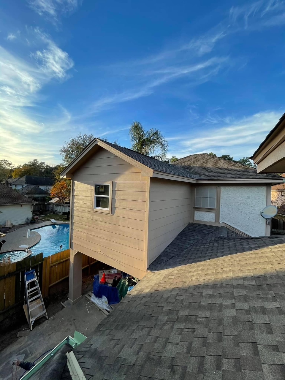 Second-story room addition with new siding and roofing