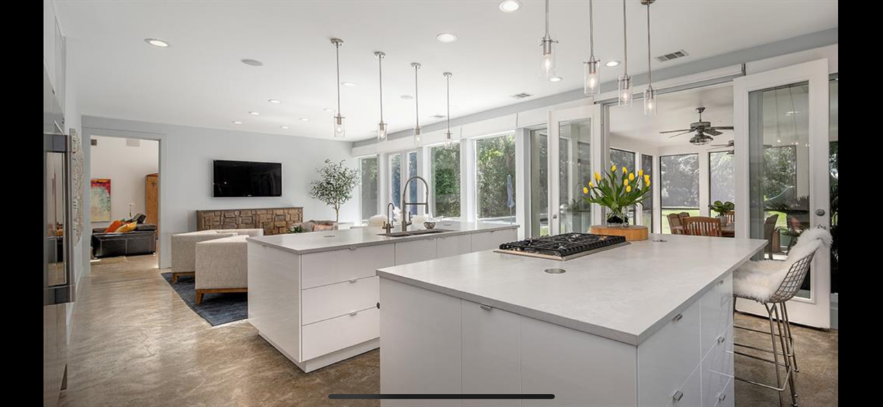 Wide view of modern open-concept kitchen with oversized island