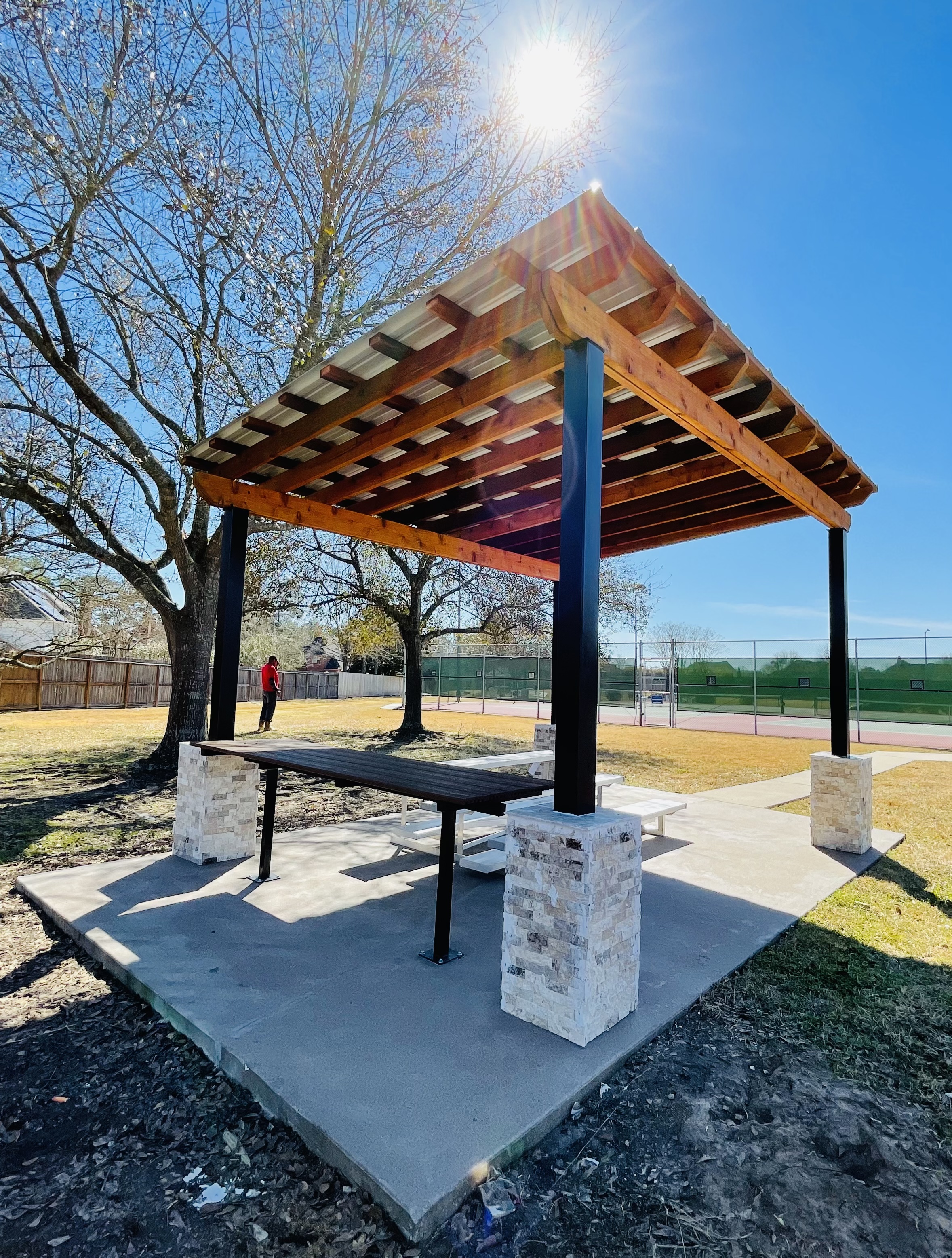 Completed custom pergola with wood top and stone columns